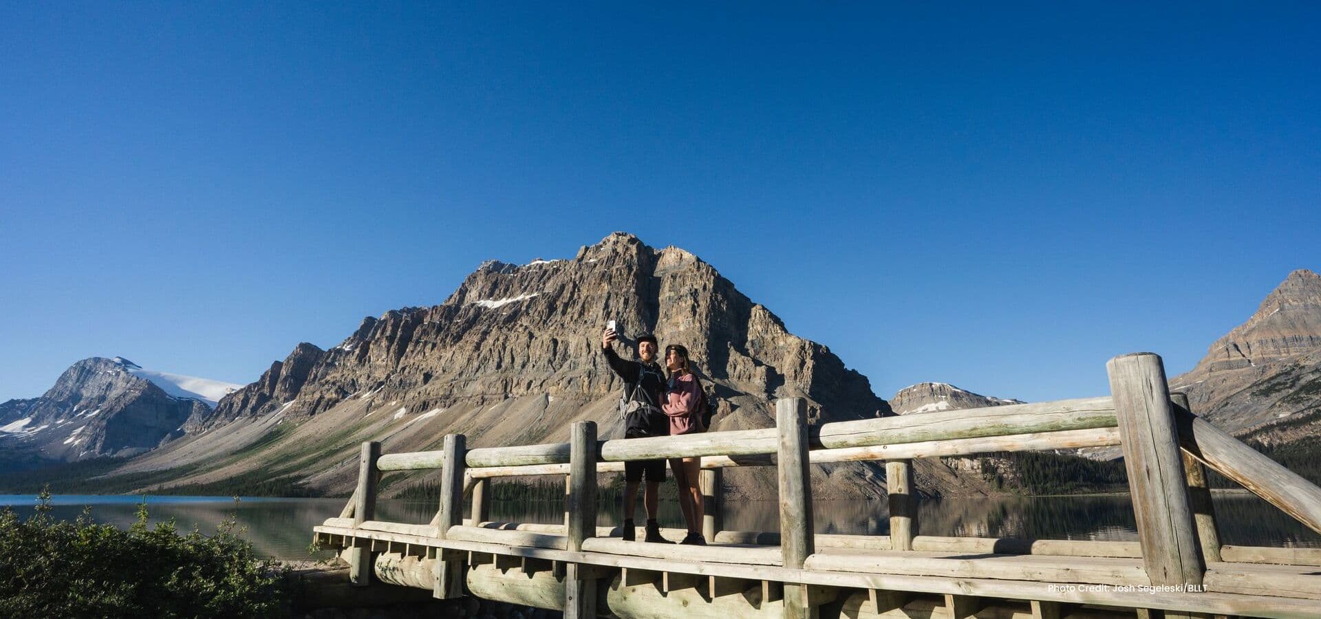 Two guests on a bridge in Banff National Park. Photo courtesy of BLLT. Two guests on a bridge in Banff National Park. Photo courtesy of BLLT.