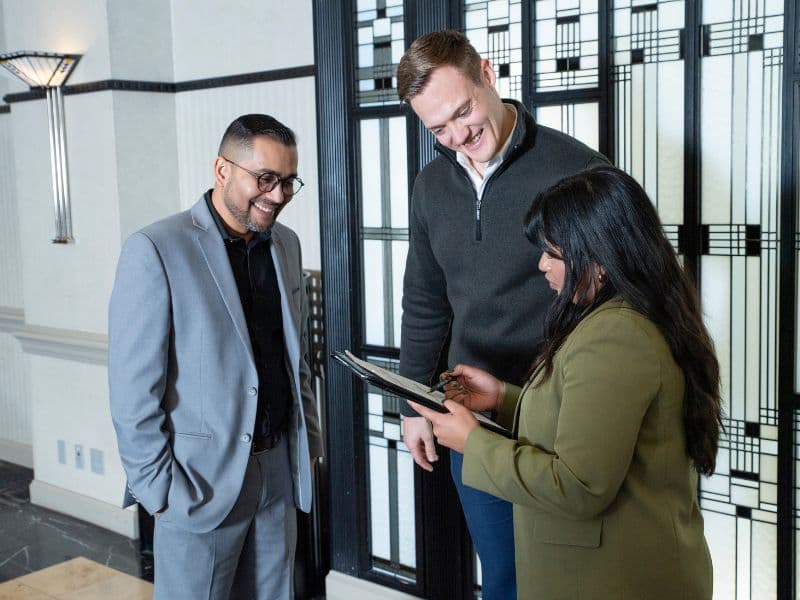 Hotel account executive discussing paperwork with two guests. Photo credit BLLHA and Accor Hotels & Resorts Hotel account executive discussing paperwork with two guests. Photo credit BLLHA and Accor Hotels & Resorts